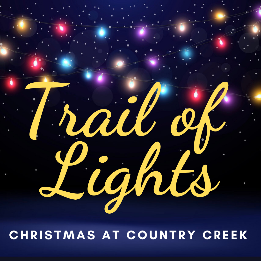 Colorful holiday lights illuminate a dark night sky, featuring the text "Trail of Lights" and "Christmas at Country Creek," promoting a festive Christmas event.